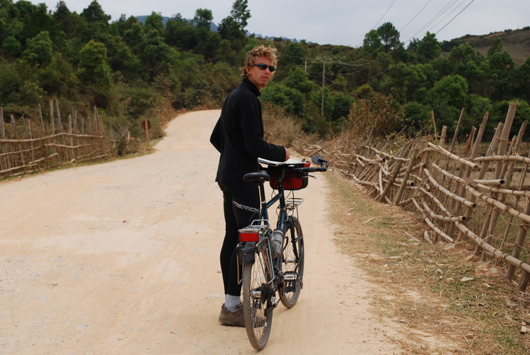 man in black on a dirt road